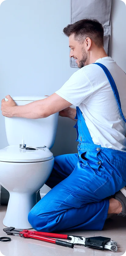 Dubai plumber fixing toilet with tools during bathroom maintenance service by Ayan Home Decor