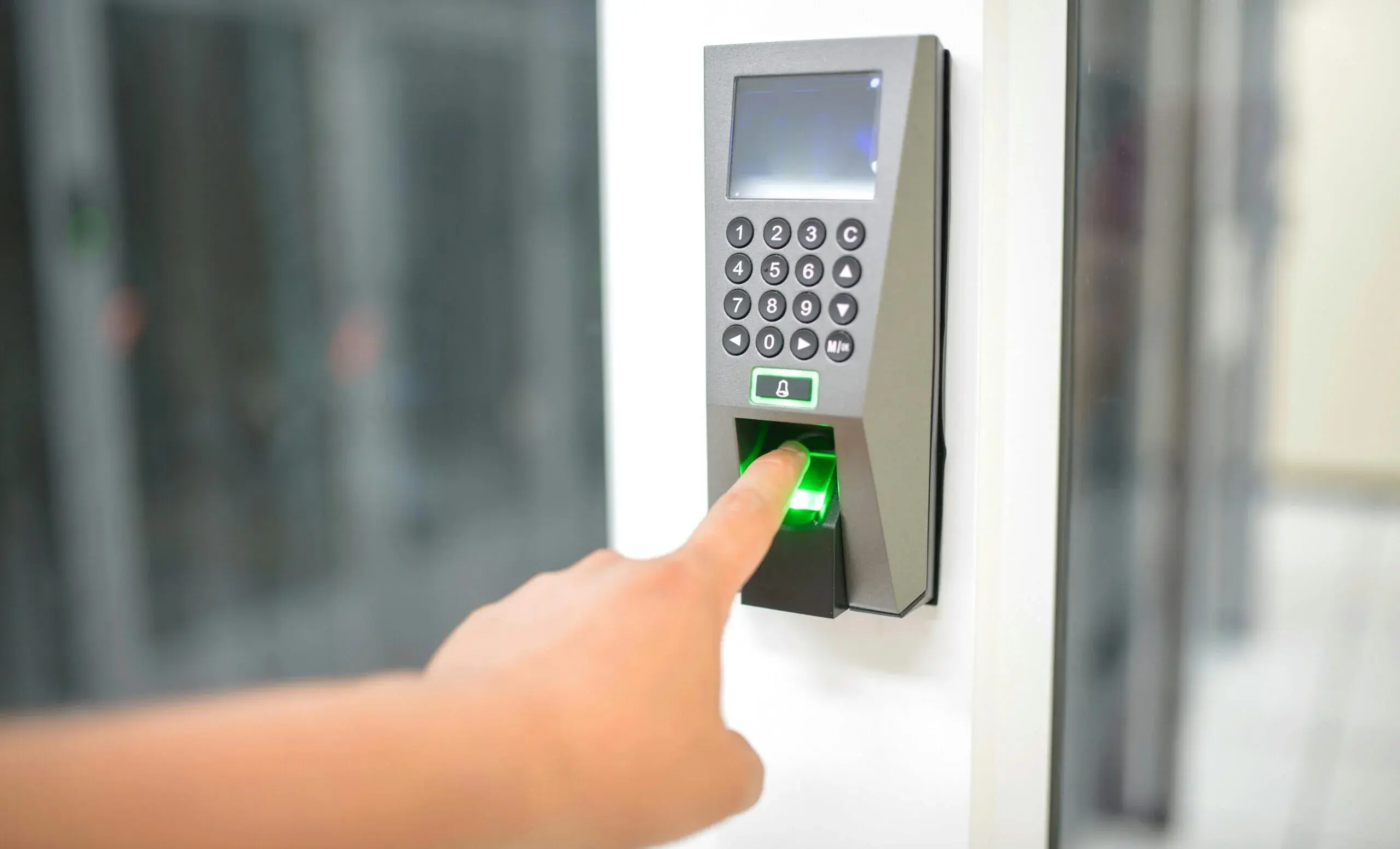 Hand using biometric fingerprint scanner and keypad for secure digital lock access in Dubai